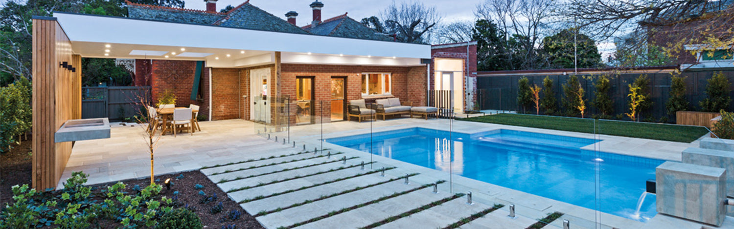 Glass pool fence installed around swimming pool, designed for Australian homes